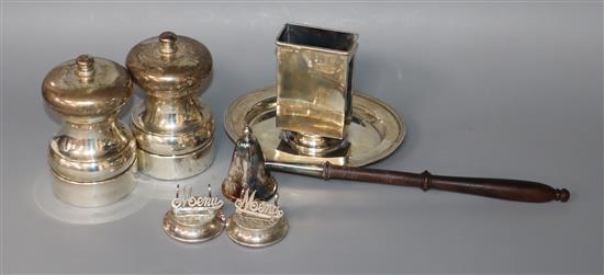 A George V silver matchbox holder stand, a pair of modern silver mounted salt and pepper mills, pair of menu holders etc.
